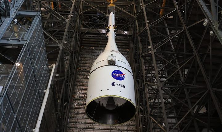Artemis II's Orion spacecraft being lifted in the Vehicle Assembly Building. ©NASA