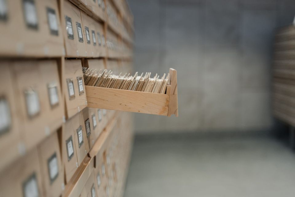 Image: One drawer of a large card cataloguing system is open