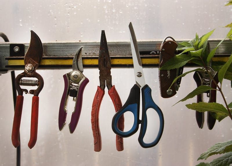 Image: Gardening tools hanging on a magnetic strip.