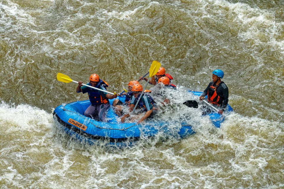 Image: White water rafters paddling through a rough section of river