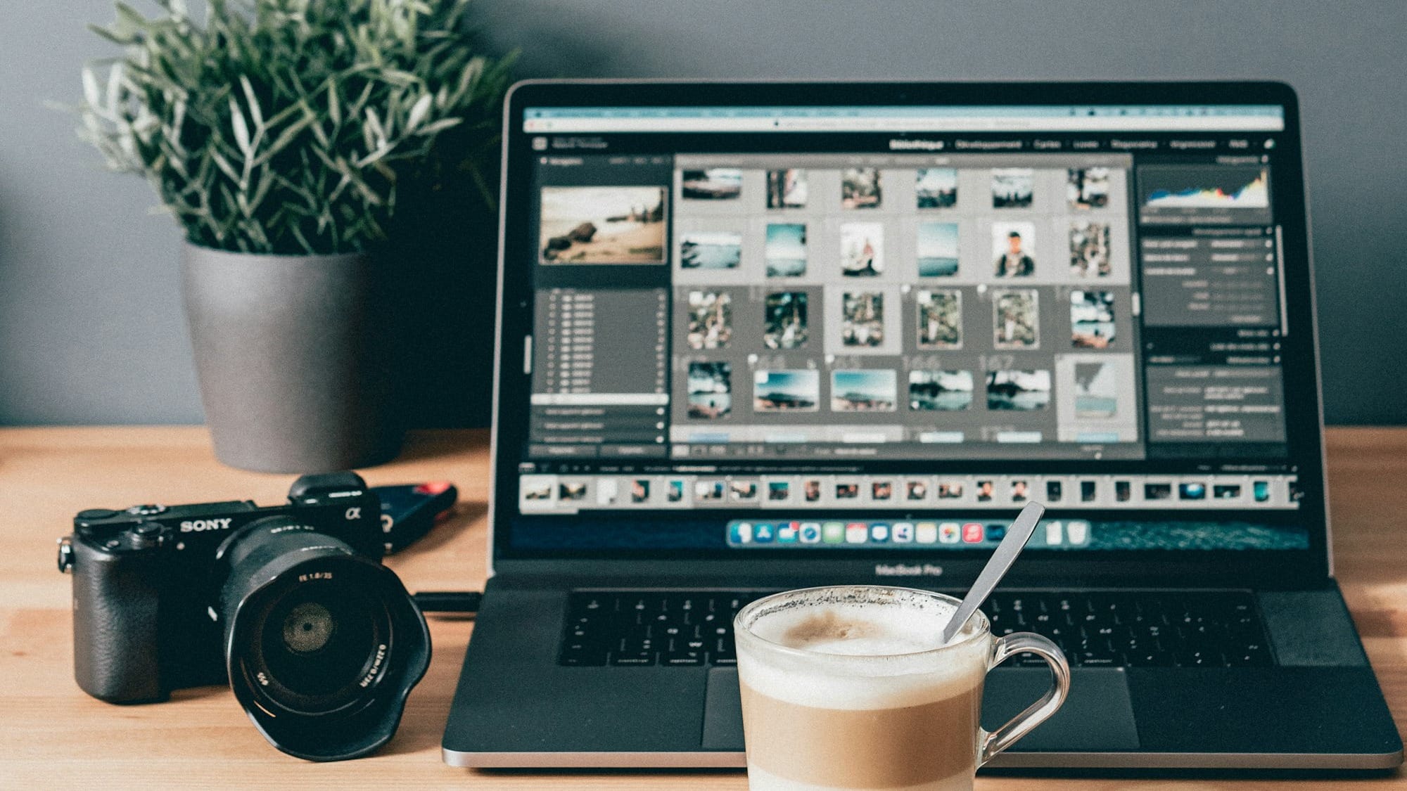 black laptop computer beside white ceramic mug on brown wooden table