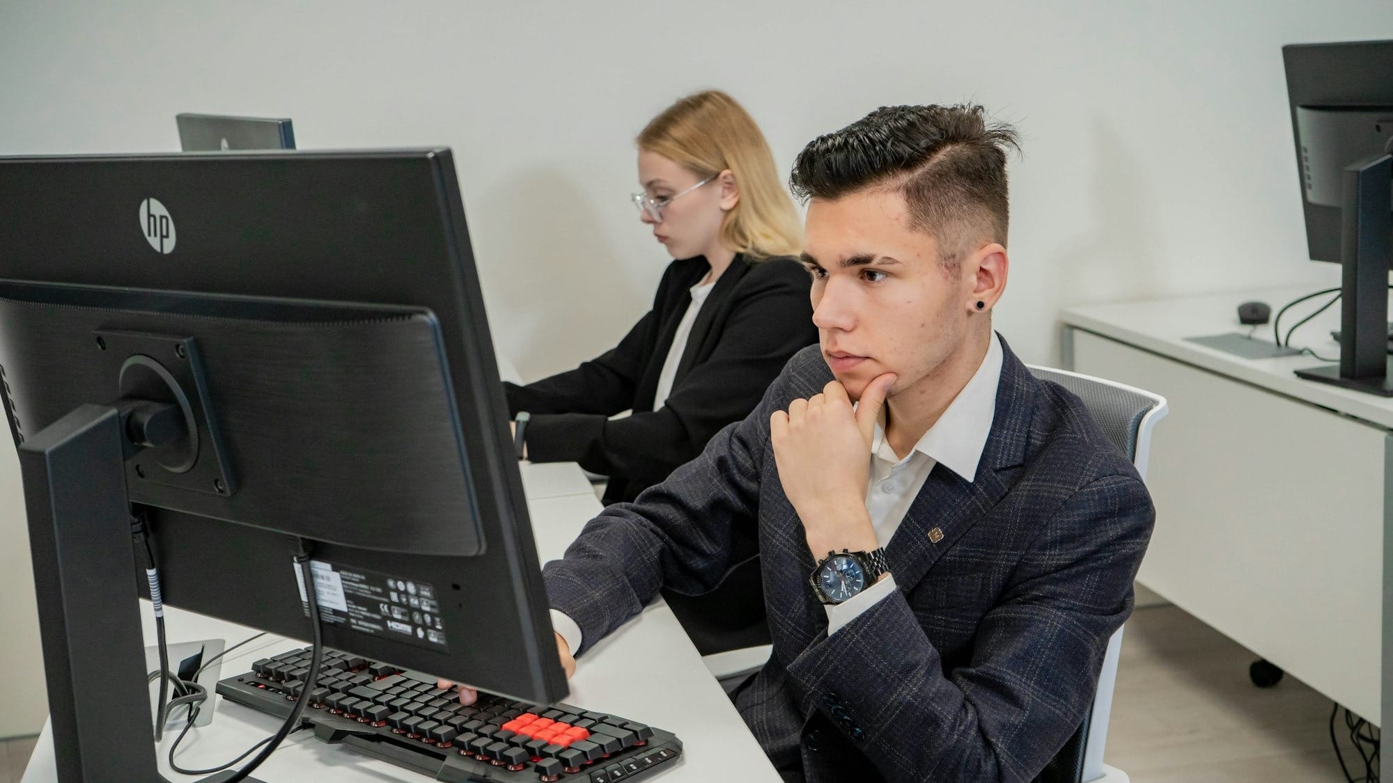 a man sitting at a desk in front of a computer