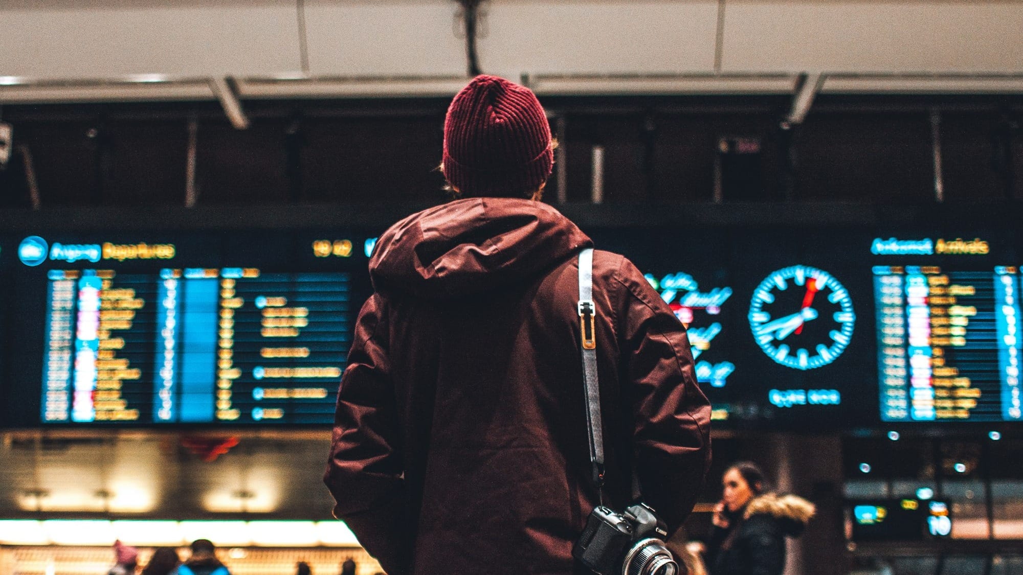 person looking up to the flight schedules