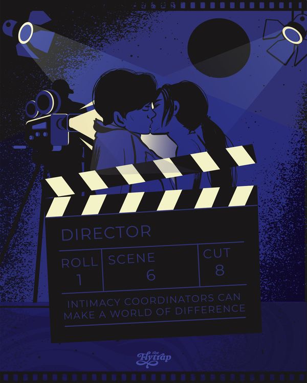 Two people kiss behind a film slate.