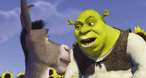 Shrek and Donkey from the movie Shrek. Shrek's mouth is open while Donkey looks at him attentively.