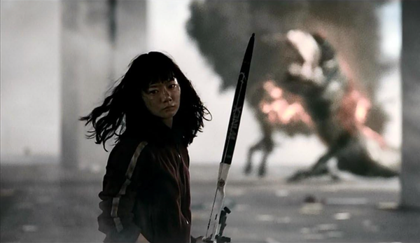 Bae Doona, a South Korean actor, wields an apocalyptic weapon as a fiery entity burns in the background