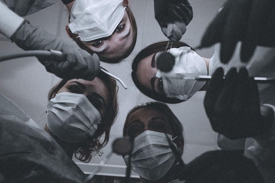 women wearing face masks holding dental tools
