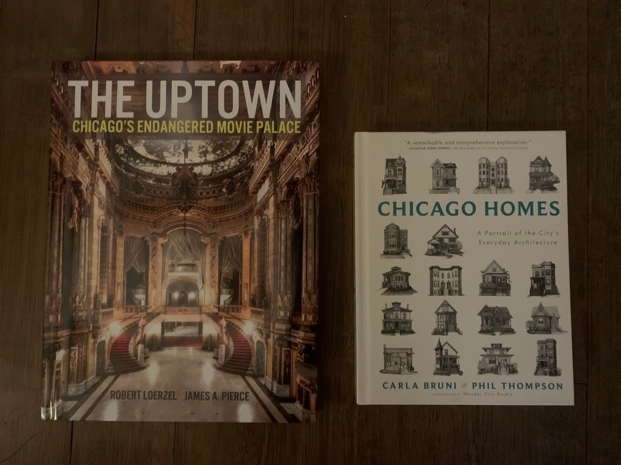 Two books: The Uptown and Chicago Homes. The former is oversized and features a color photograph of the lavish interior of the Uptown Theatre. Chicago Homes is smaller and features a grid of small line drawings of homes.