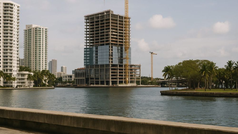 Waterfront skyscraper construction in Miami's Brickell district, highlighting South Florida real estate development.