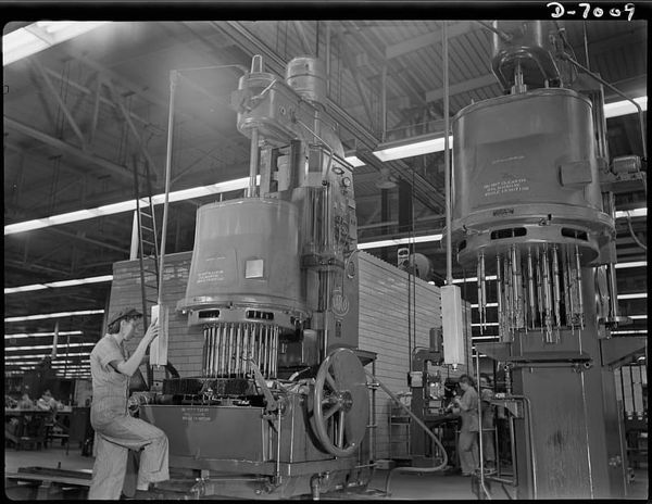 A man-sized machine and a man-sized job are effectively handled by 21-year-old Virginia Grochowski of Milwaukee, Wisconsin.