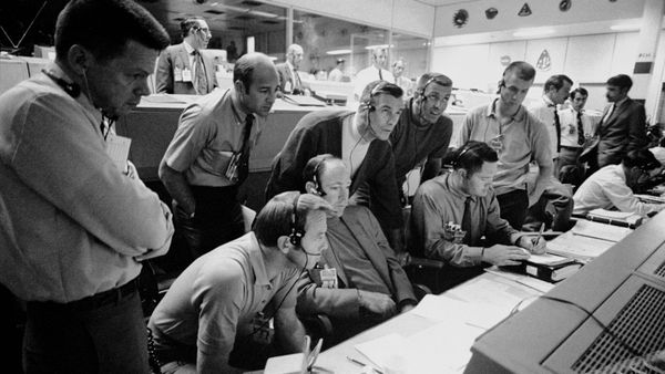 6 astronauts & 2 flight controllers monitor the console activity in the Mission Operations Control Room (MOCR) of the Mission Control Center (MCC) during the Apollo 13 lunar mission.