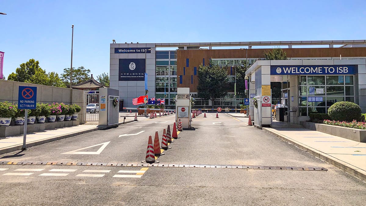 International School of Beijing campus entrance featuring security barriers and contemporary educational facility design.