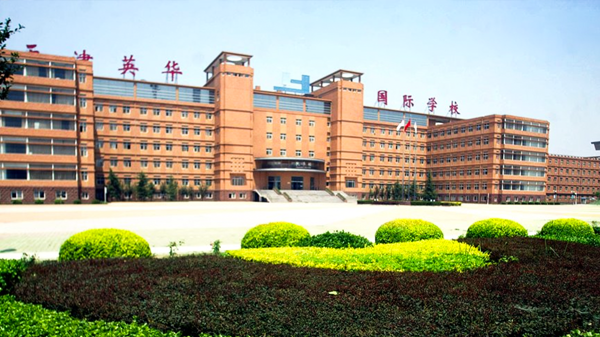 Yinghua Academy of Tianjin campus with orange buildings and manicured green landscaping displayed.