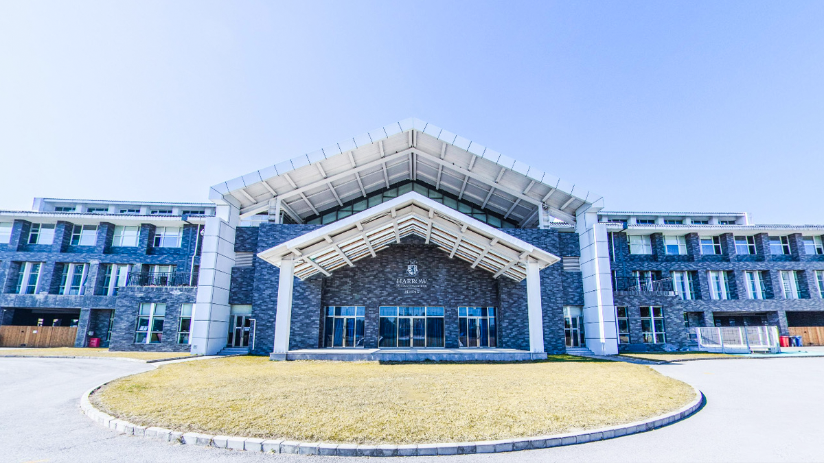 Harrow International School Beijing campus featuring modern architecture with a distinctive blue stone exterior design.