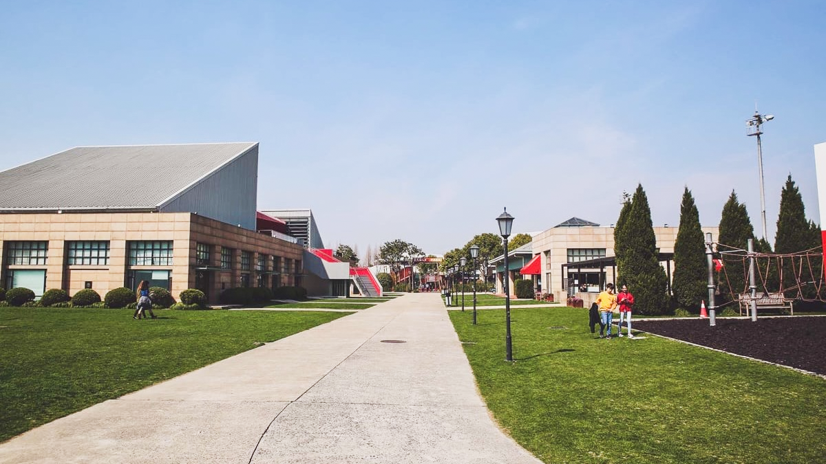 Shanghai American School campus showing modern and traditional buildings with green lawns and walkways.