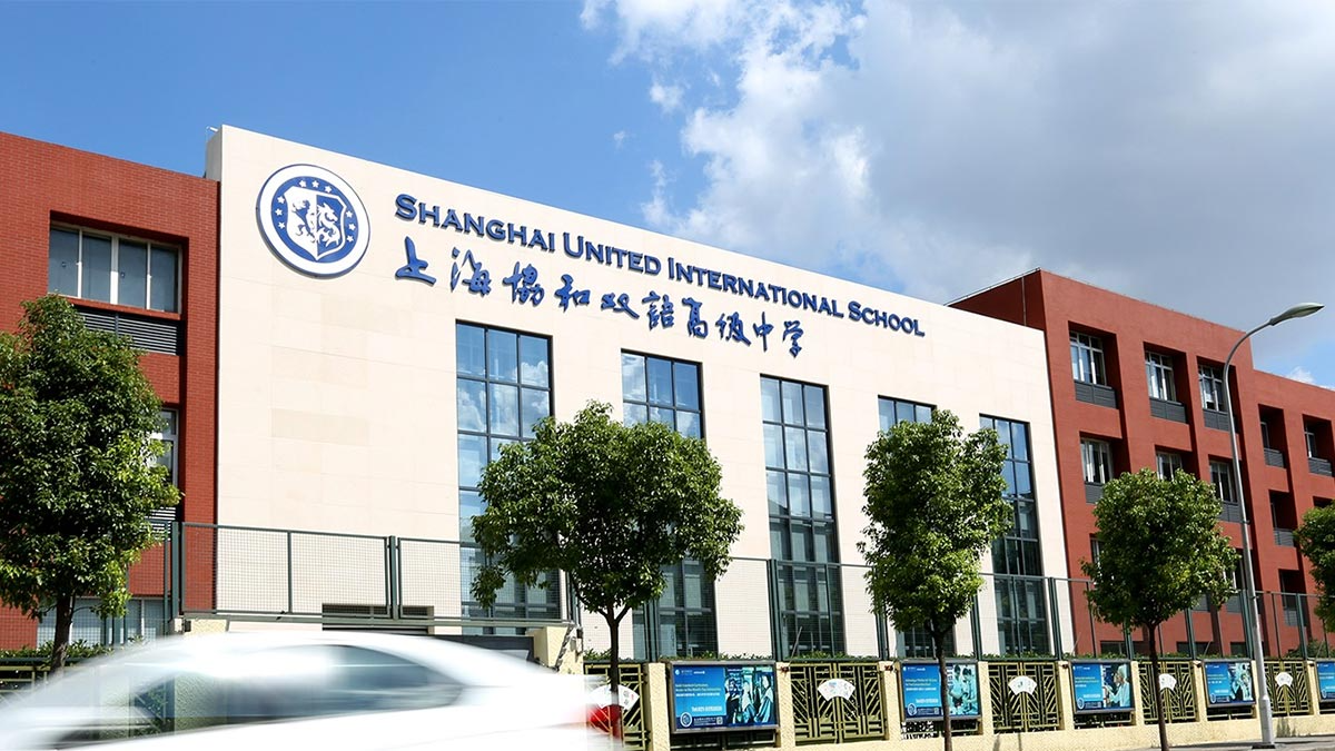 Shanghai United International School Gubei Campus featuring modern brick architecture with bilingual signage and landscaping.