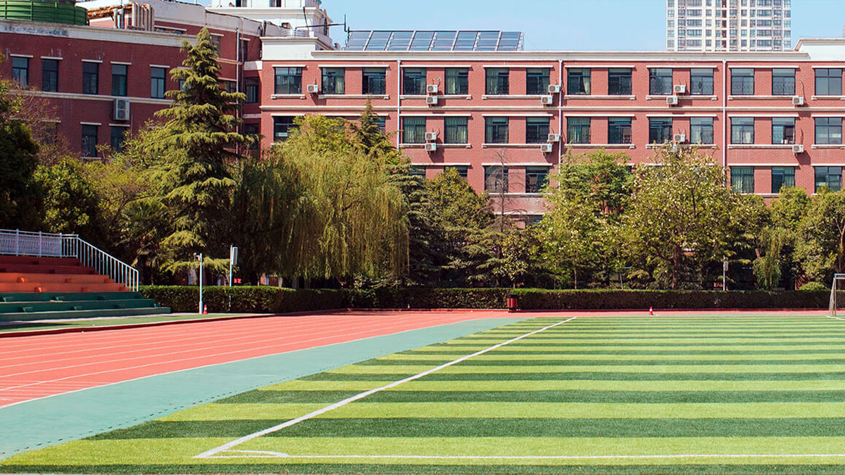 Henan Zhengzhou Jianye International School showing a running track and soccer field.