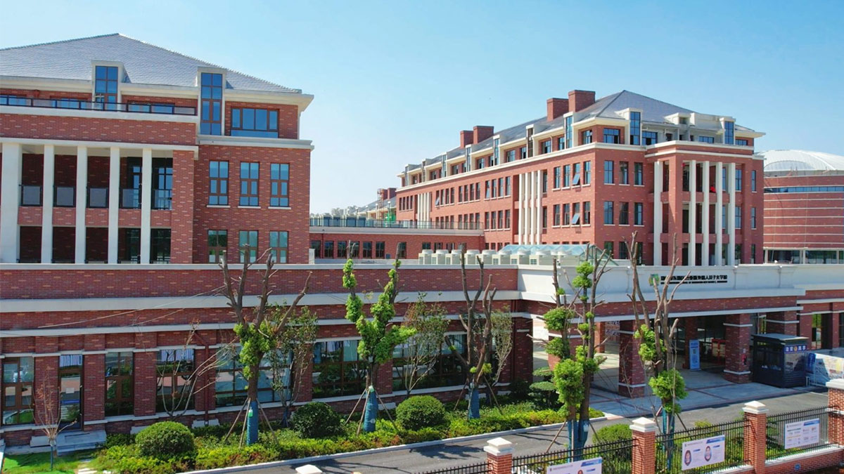 Sias International School campus buildings with landscaped grounds and blue sky.