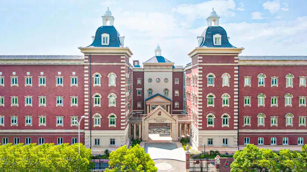 Wellington College International Shanghai featuring grand Victorian-style architecture with distinctive blue copper dome towers.