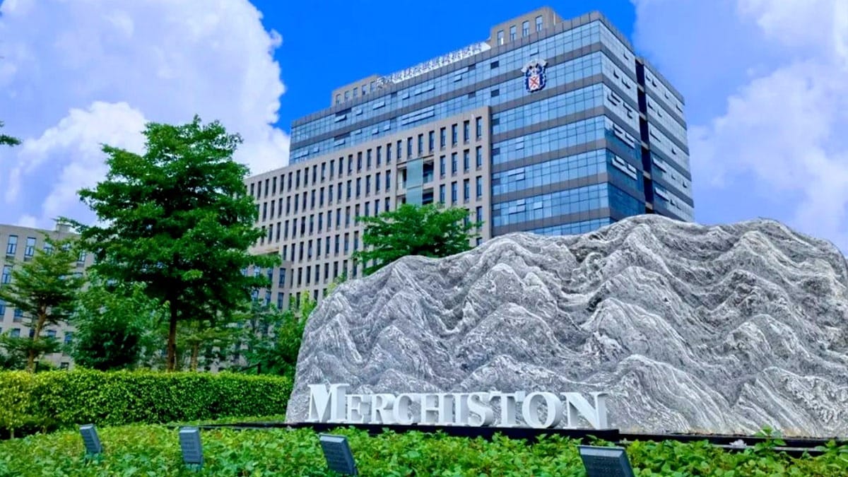 Merchiston Academy Songshan Lake campus with stone monument and modern glass building