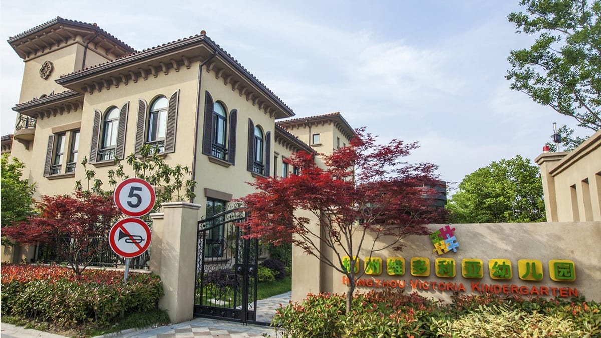 Hangzhou Victoria Kindergarten JiaRun Campus entrance with Mediterranean-style buildings