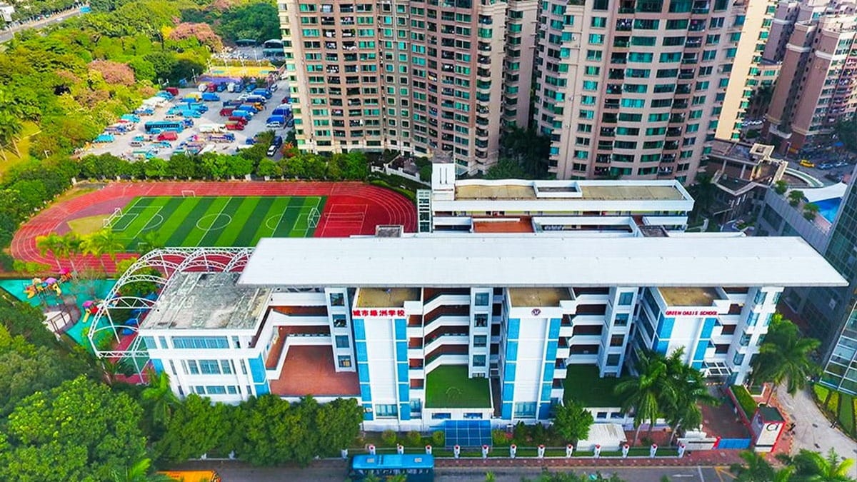 Shenzhen Oasis International School aerial view with sports field and modern campus buildings