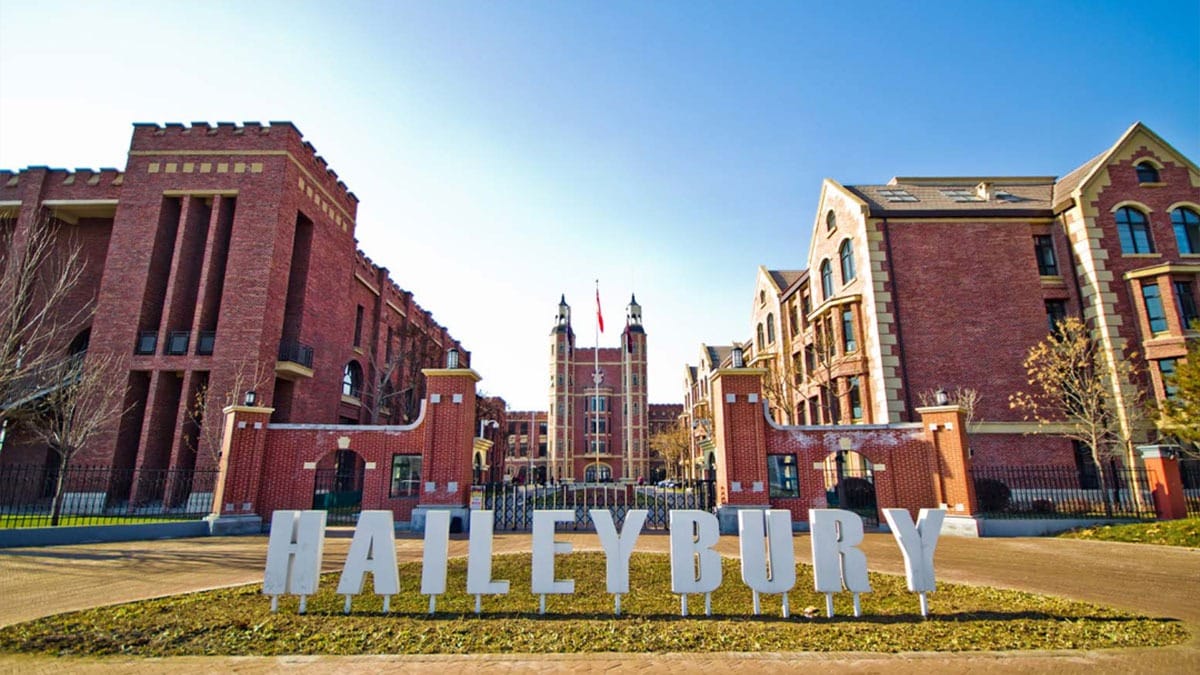 Haileybury Schools Tianjin campus featuring brick buildings and large letter sign