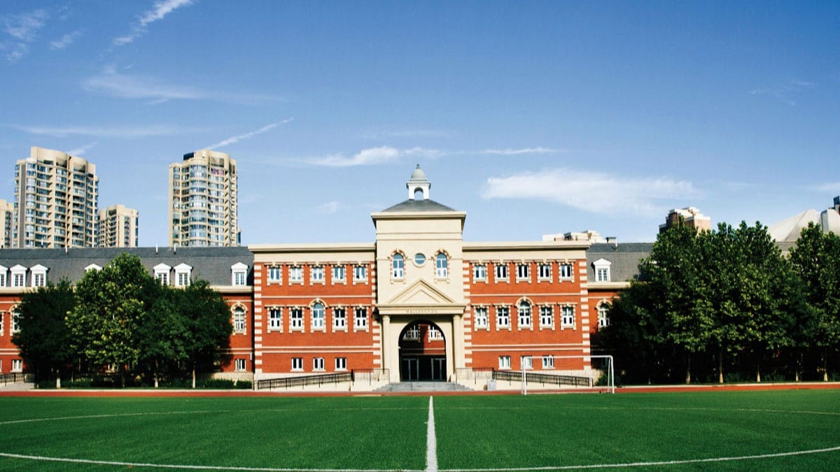 Wellington College International Tianjin campus with sports field and historic architecture