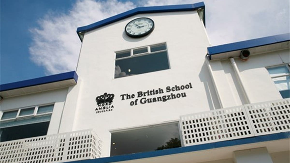 The British School of Guangzhou white building with blue trim and clock tower