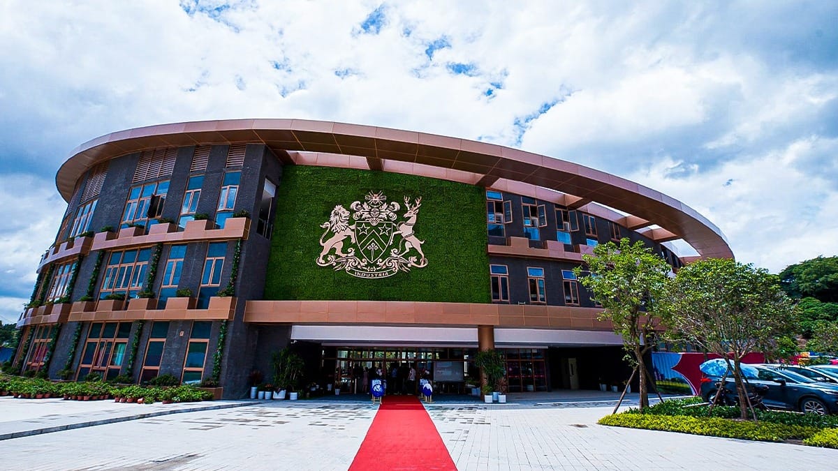 Fettes College Guangzhou entrance with curved architecture and green wall crest display