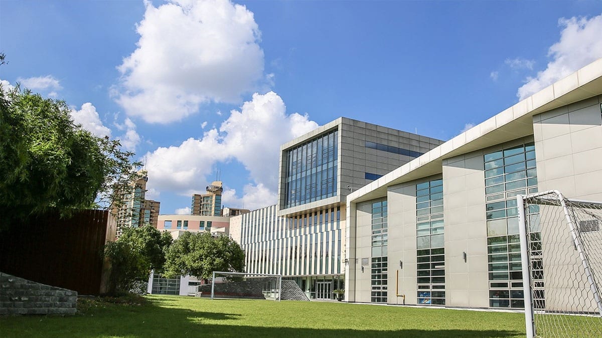 Concordia International School Shanghai contemporary campus with white buildings and green field