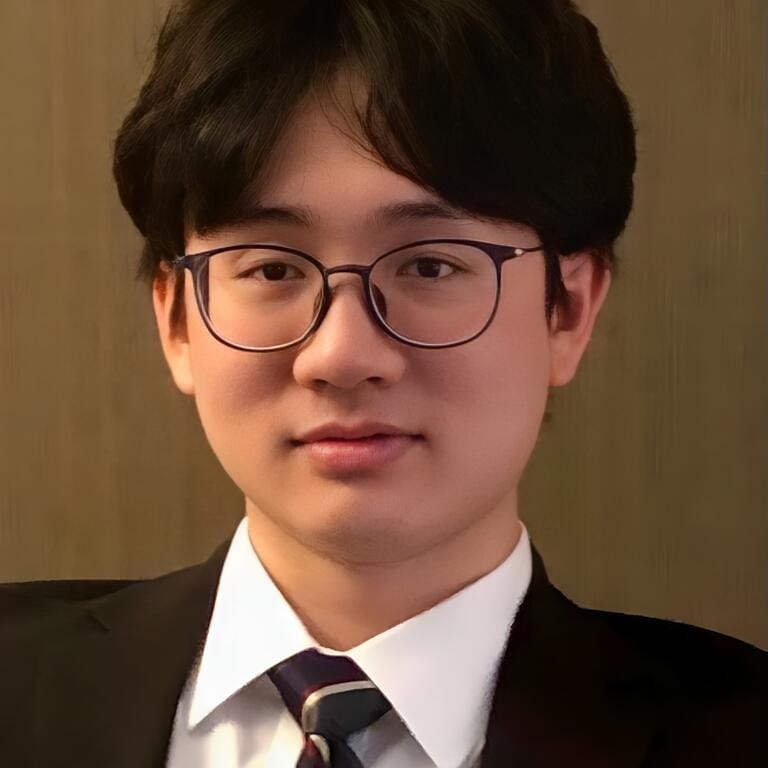 Shenzhen Yaohua Experimental School graduate Yuan Cao in formal attire with glasses