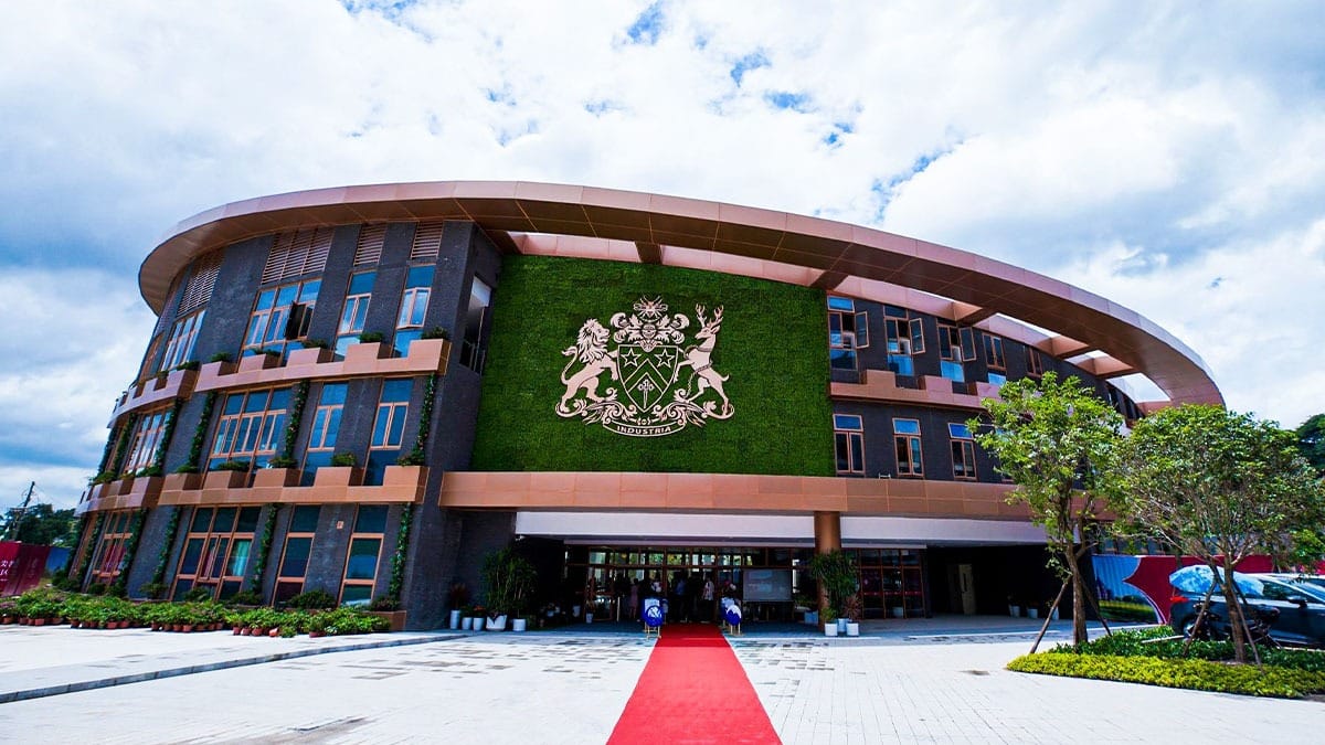 Fettes College Guangzhou circular building with green wall featuring school crest