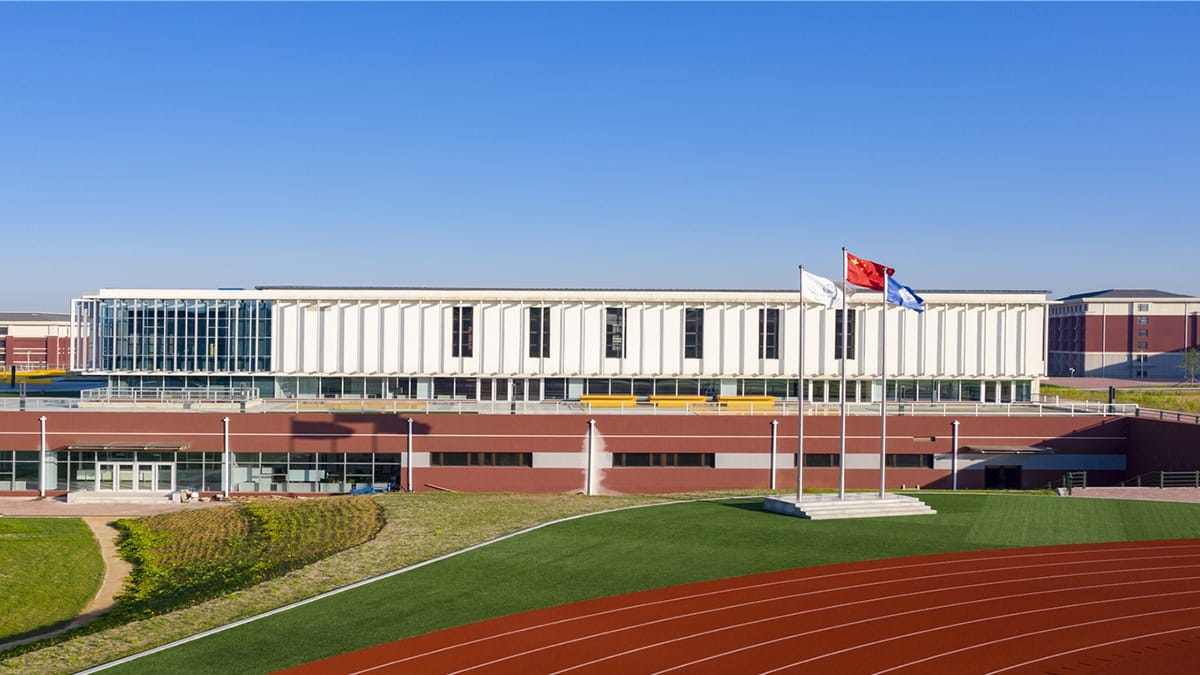 Oriental Cambridge International School building with athletic track and field