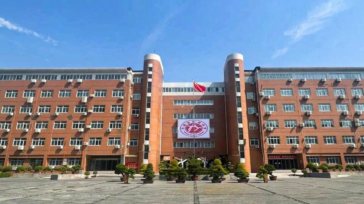 Henan Sports School orange brick building with twin towers and Chinese flag