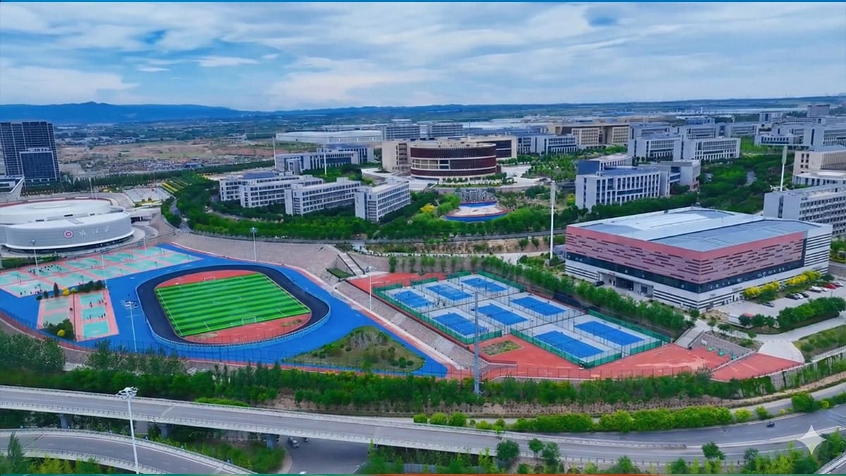 Jinzhong Sports School aerial view showing track, tennis courts, and training facilities