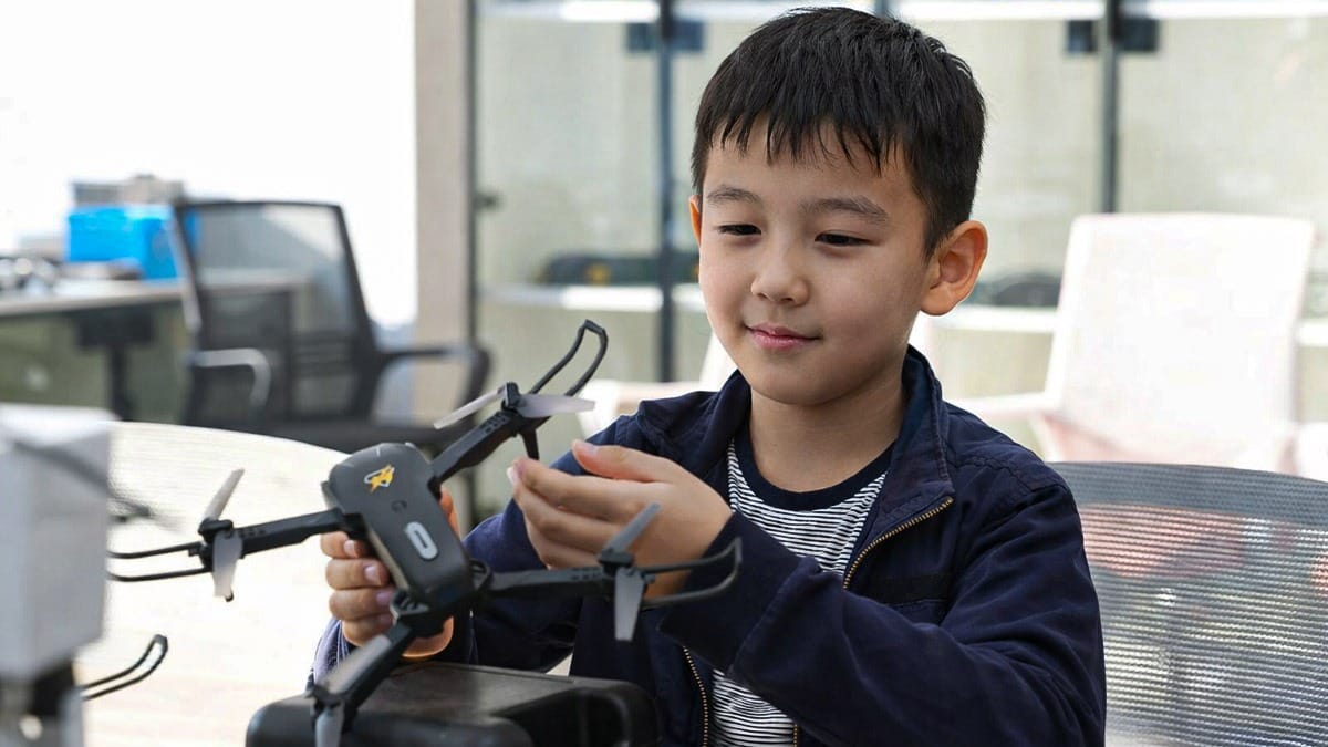 Arman assembling a drone during hands-on STEM education program in Beijing