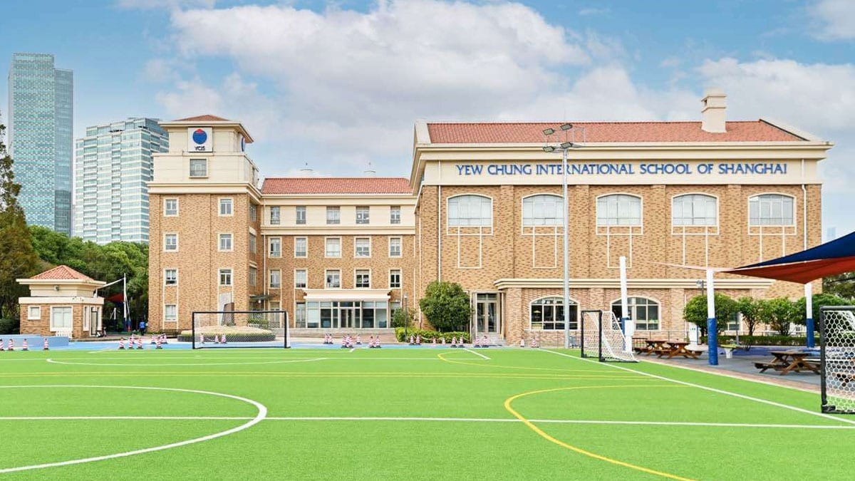 Yew Chung International School of Shanghai building exterior with green sports field
