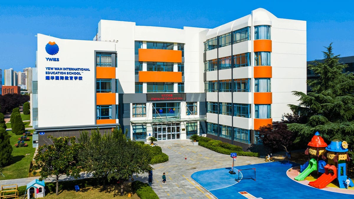 Yew Wah International Education School Yantai Campus aerial view with sports courts and playground