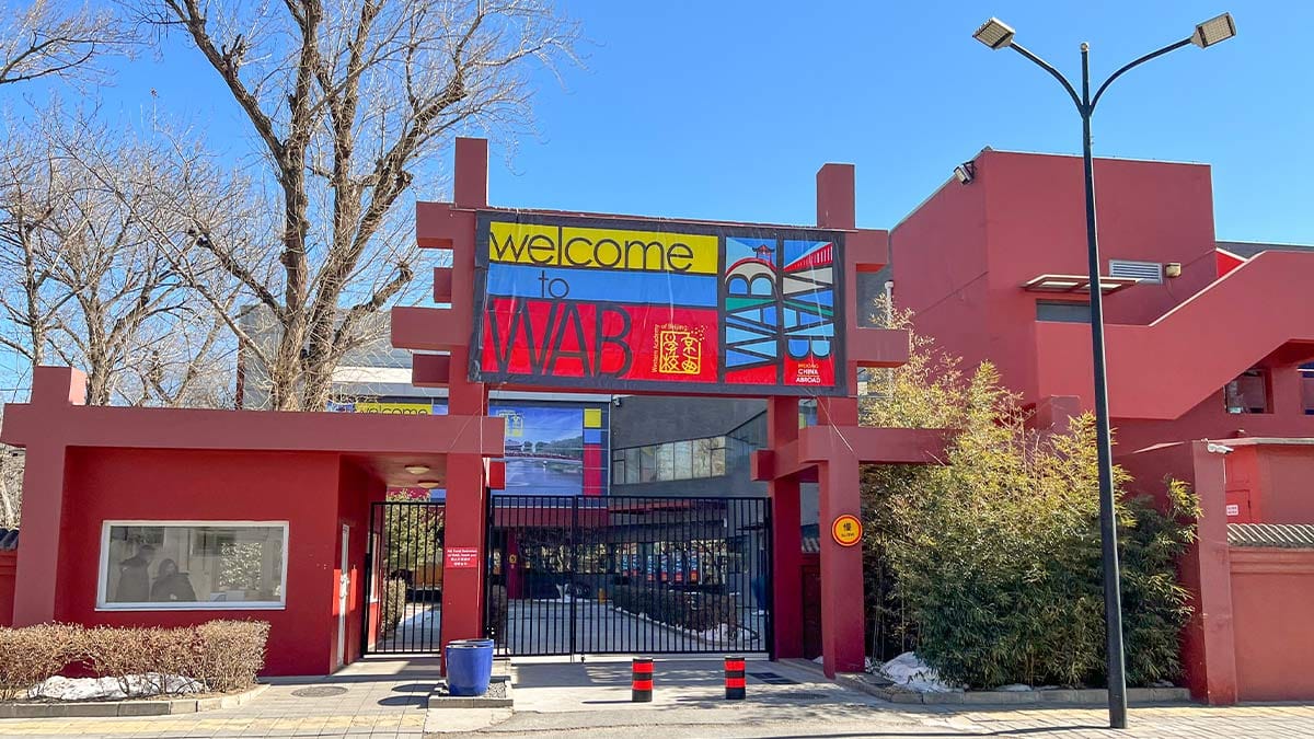 Western Academy of Beijing colorful red campus entrance with Welcome to WAB banner