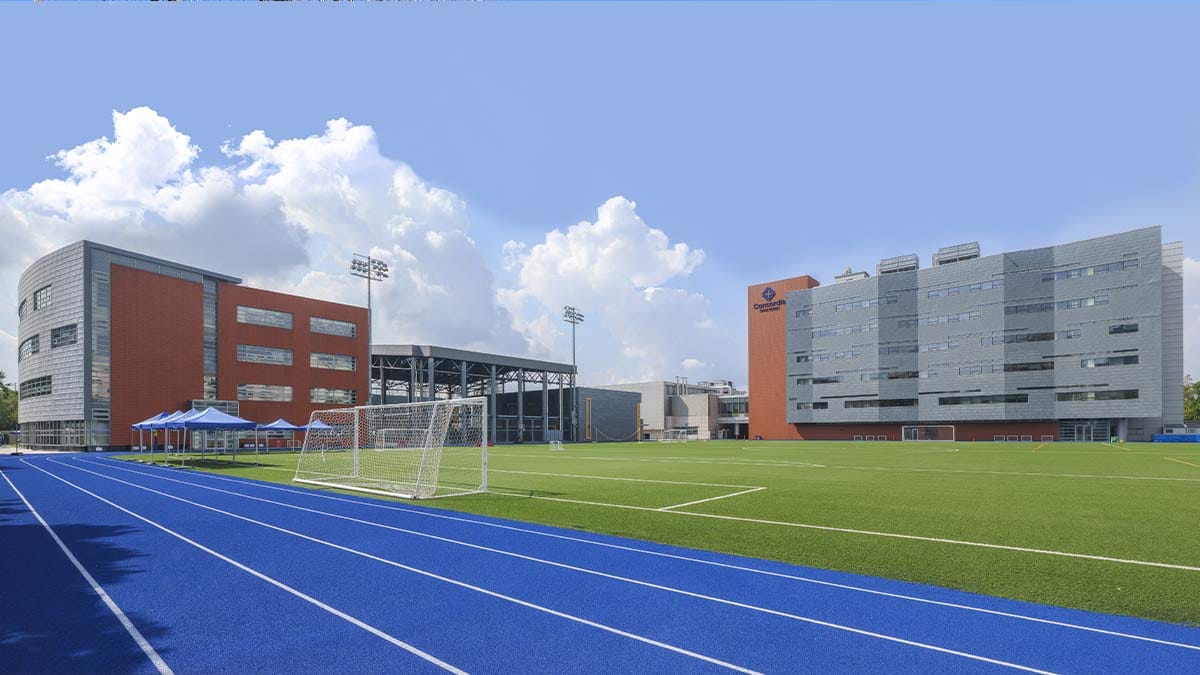 Concordia International School Shanghai athletic field with blue running track and buildings