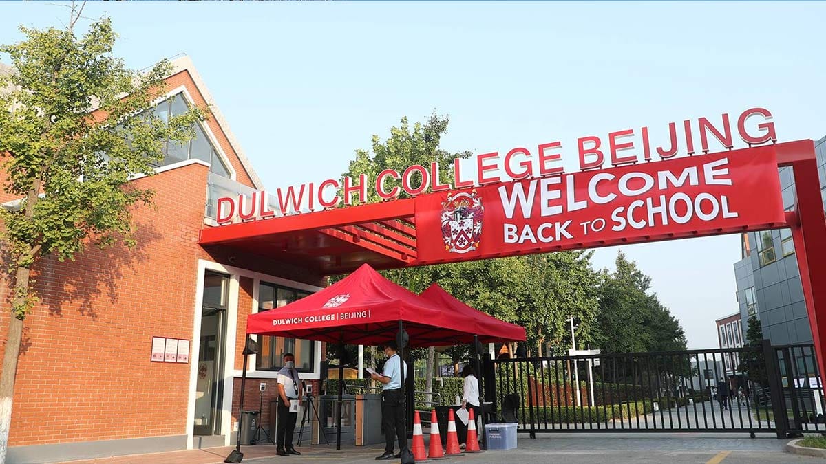 Dulwich College Beijing red entrance arch with Welcome Back to School signage