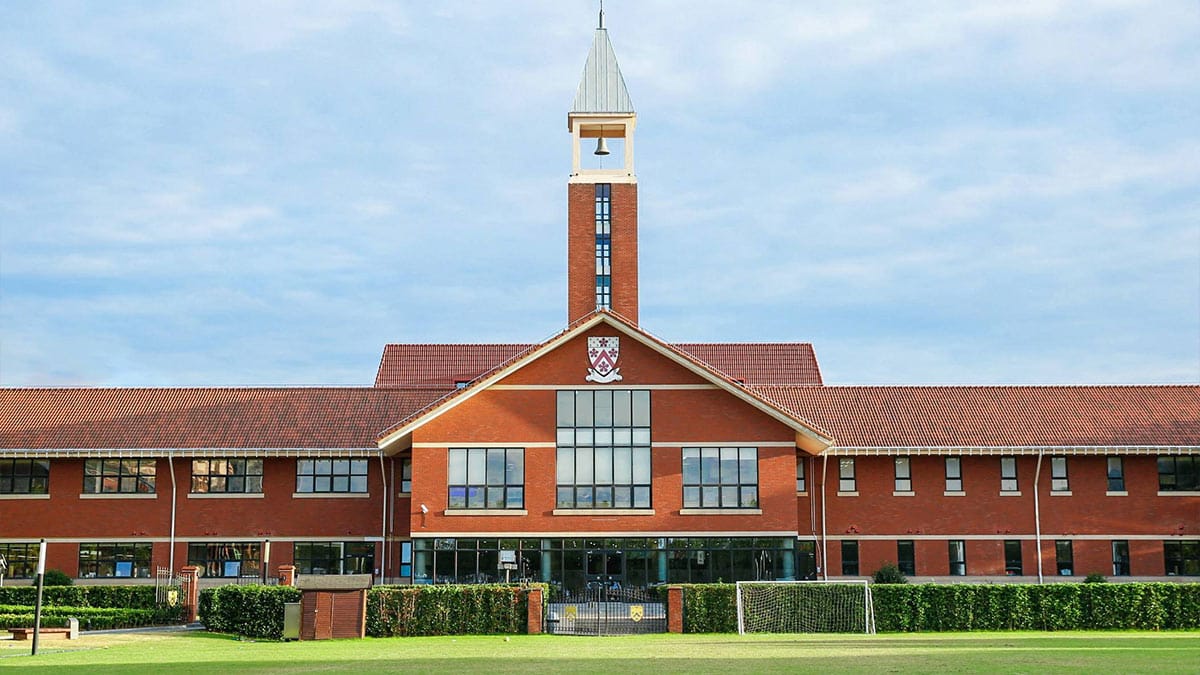 Dulwich College Shanghai Pudong red brick main building with bell tower and field