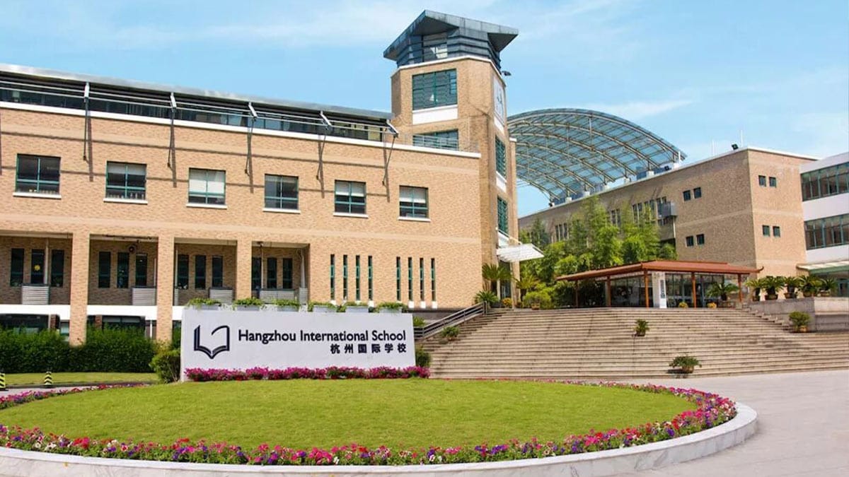 Hangzhou International School campus entrance with flower garden and clock tower