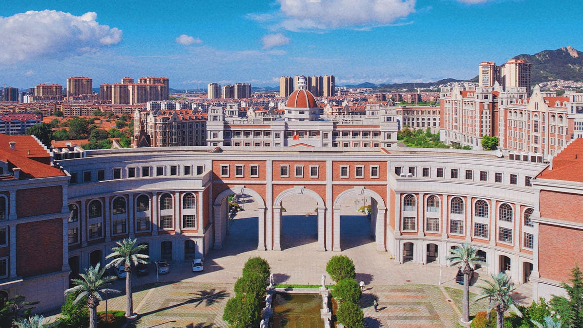 Malvern College Chengdu grand arched entrance with classical brick architecture aerial view