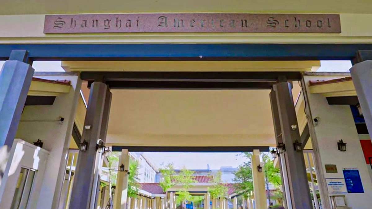 Shanghai American School entrance archway with engraved stone name sign