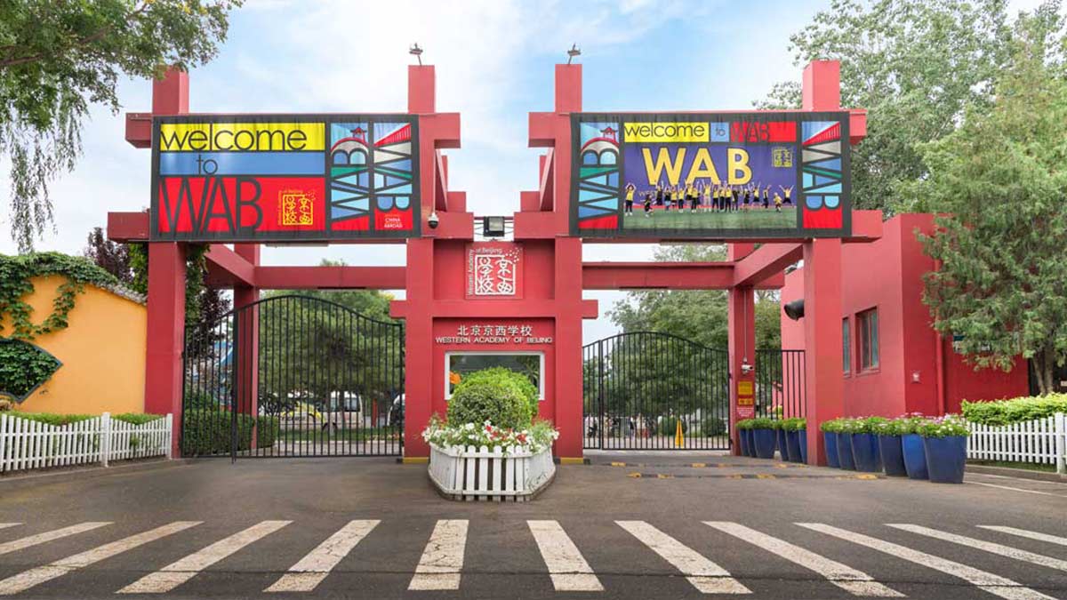 Western Academy of Beijing WAB red gate entrance with Welcome to WAB banners