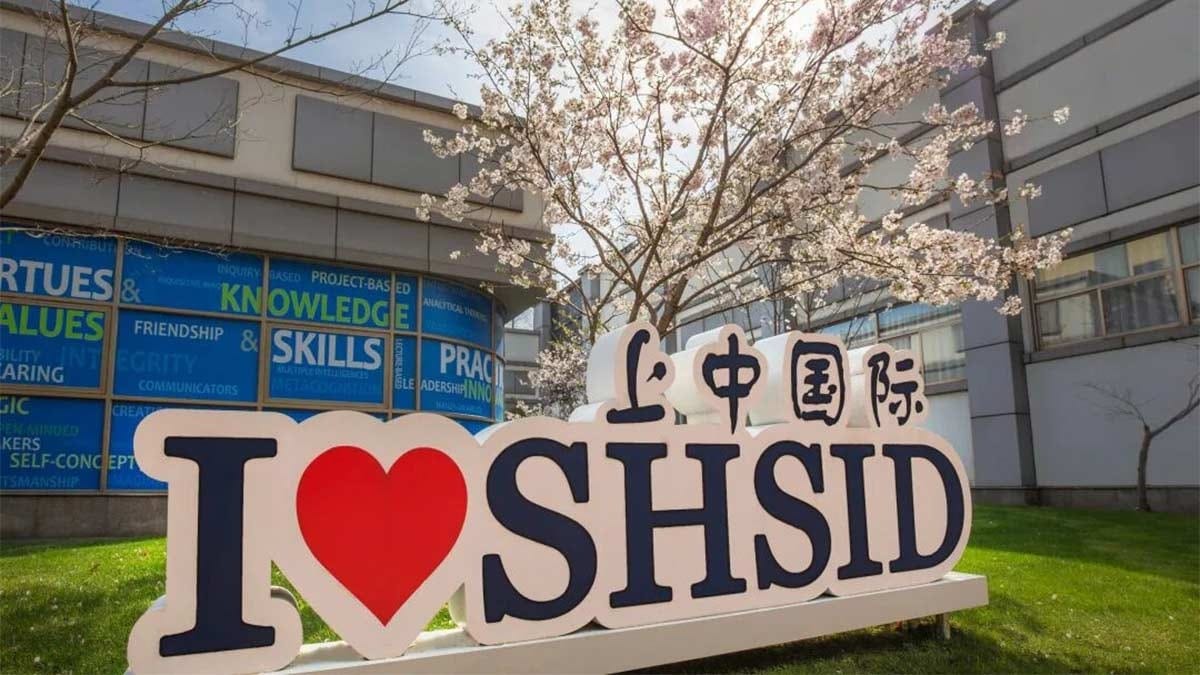 Shanghai High School International Division campus sign with cherry blossoms