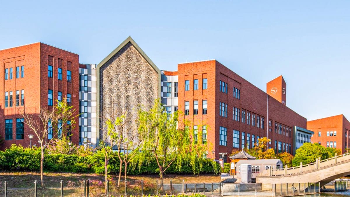 Dulwich College Shanghai Puxi red-brick campus with clock tower and stone bridge