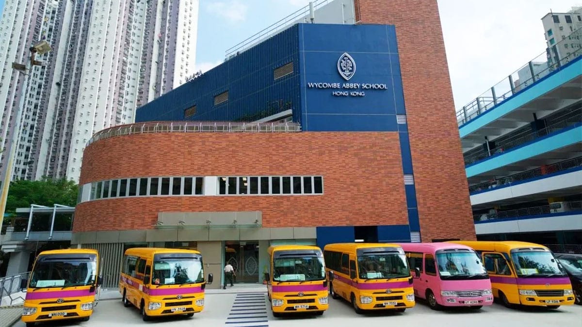 Wycombe Abbey School Hong Kong campus building with school buses parked outside